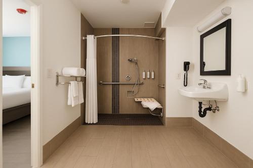 a bathroom with a shower and a sink at Travelodge by Wyndham LAX in El Segundo