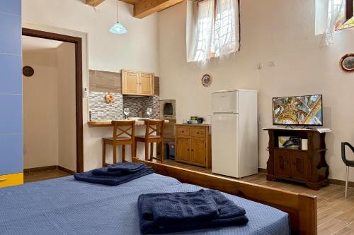 a kitchen with two beds and a refrigerator at Studio privato centro storico Oristano in Oristano