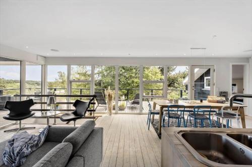 a living room with a couch and a table at JB400-Brovst-Solsortevej-7 in Tranum