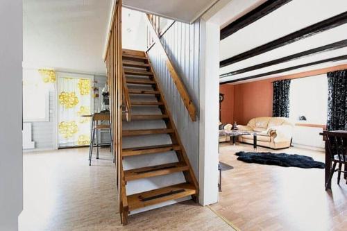 a wooden staircase in a room with a living room at KAL472-Malilla-Virserumsvaegen-28 in Bäckeby