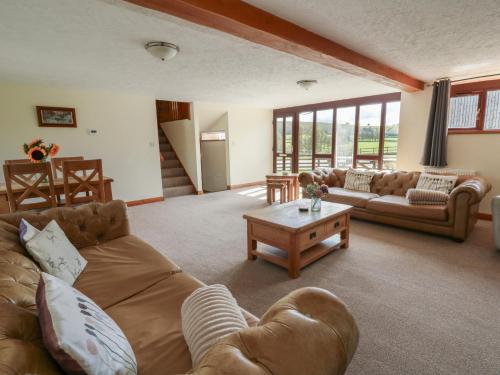 a living room with a couch and a coffee table at Glanyrafon in Rhayader