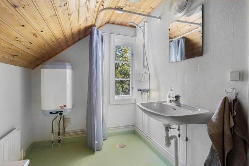 a bathroom with a sink and a window at KAL344-Nybro-Krumhall-110 in Florhult