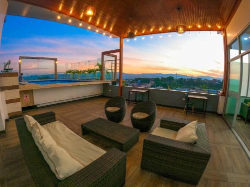 a living room with couches and a balcony with a view at RBB BRITO HOTEL in Tarapoto