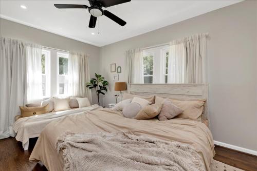 a bedroom with a large bed with a ceiling fan at #TheLakeHouse - Fun, Fishing & Games - Near Airport,BJCC,Downtown,Crossplex in Birmingham