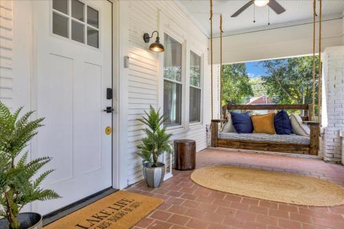 a porch with a bench on a front door at #TheLakeHouse - Fun, Fishing & Games - Near Airport,BJCC,Downtown,Crossplex in Birmingham
