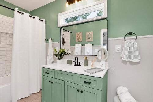 a bathroom with a sink and a mirror at #TheLakeHouse - Fun, Fishing & Games - Near Airport,BJCC,Downtown,Crossplex in Birmingham