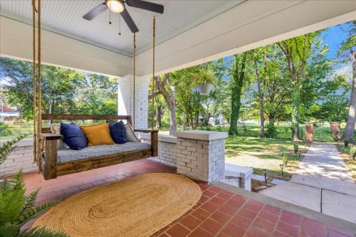 a porch with a swing and a fireplace at #TheLakeHouse - Fun, Fishing & Games - Near Airport,BJCC,Downtown,Crossplex in Birmingham