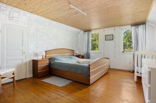 a bedroom with a bed in the corner of a room at KAL591-Hoegsby-Allgunnen-113 in Skurebo