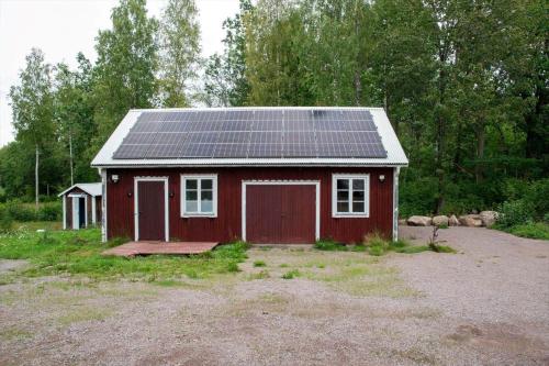 a red shed with solar panels on the roof at KAL558-Virserum-Holm-6 in Holm