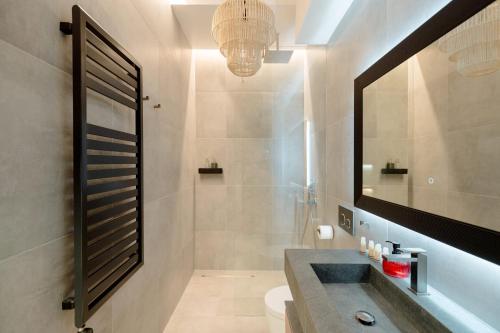 a bathroom with a sink and a mirror at Palazzo Panfilli Central Luxury in Trieste