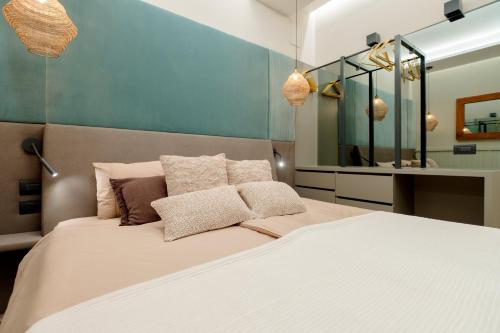 a bedroom with a large white bed with a mirror at Palazzo Panfilli Central Luxury in Trieste