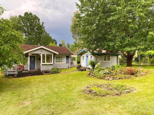 a home with a yard with two small houses at KAL570-Fagerhult-Solaeng-419 in Fagerhult