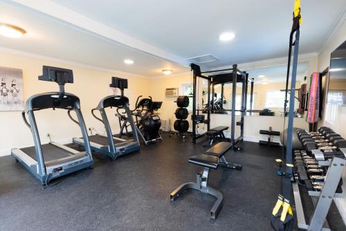 a gym with several tread machines in a room at Aspinquid Resort in Ogunquit