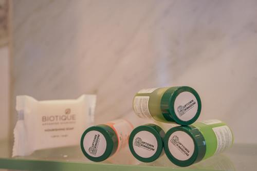 two green and white cups sitting on top of a shelf at The Uptown Kingdom Luxury Homestay in Mukteswar