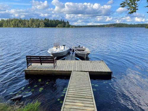 a boat sitting on a dock on a lake at KAL570-Fagerhult-Solaeng-419 in Fagerhult
