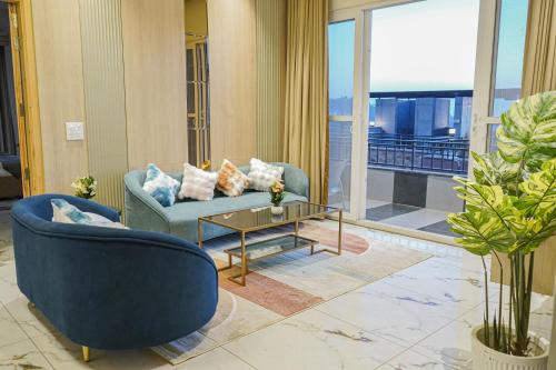 a living room with a couch and a table at The Uptown Kingdom Luxury Homestay in Mukteswar