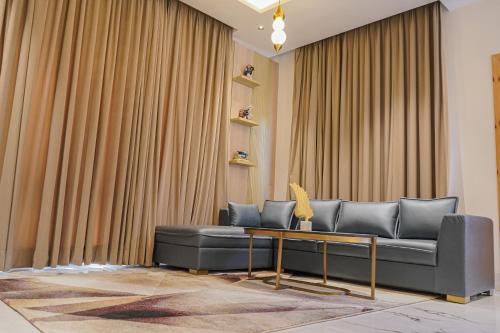 a living room with a couch and a table at The Uptown Kingdom Luxury Homestay in Mukteswar