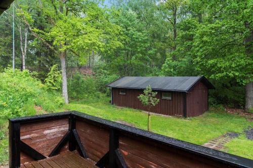 a barn with a black roof in a yard at SKA566-Vaestra-Torup-Oejesjoevaegen-9 in Västra Torup