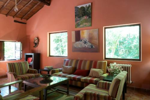 a living room with a couch and a table at Hotel rural El Jardin del Conde in Puerto de Béjar