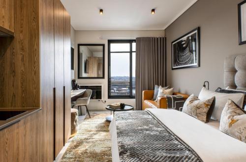 a hotel room with a bed and a living room at Menlyn Maine Residence Unit 1419 in Pretoria