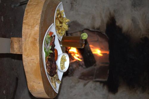a plate of food next to a pizza oven at PONDOWASI LODGE in Ibarra