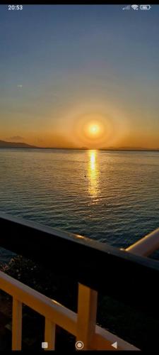 a sunset on the ocean from a cruise ship at Ervis Aparment in Agioi Theodoroi