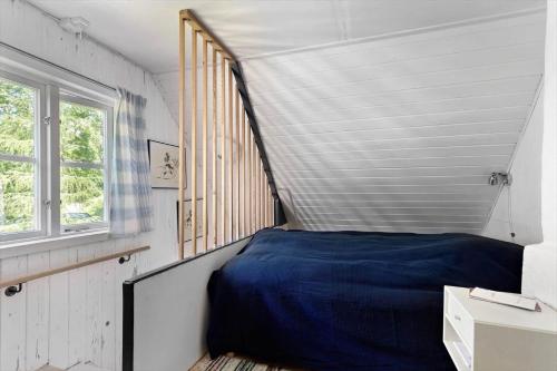 a bedroom with a blue bed and a window at BLE624-Olofstroem-Hemsjoehultsvaegen-86 in Hemsjöhult
