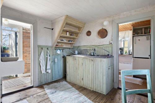 a kitchen with a sink and a refrigerator at KRO039-Vaexjoe-Norra-Areda-6 in Östra Målajord