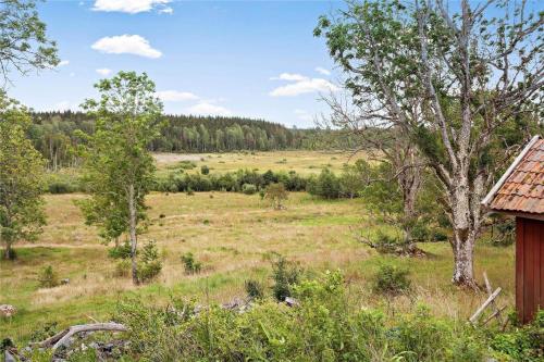 a view of a field with trees and a house at KAL430-Loenneberga-Katebo-4 in Ingelstorp
