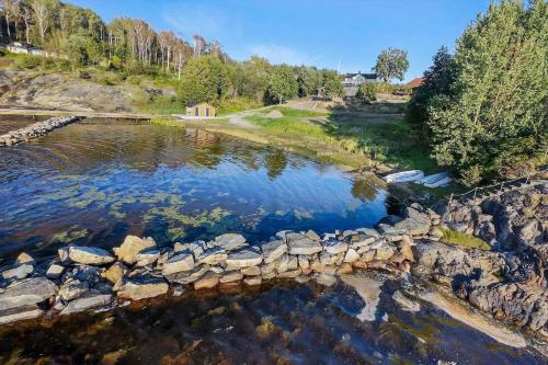 an aerial view of a river with rocks and trees at BOH607-Udevalla-Kolvik-254 in Klev