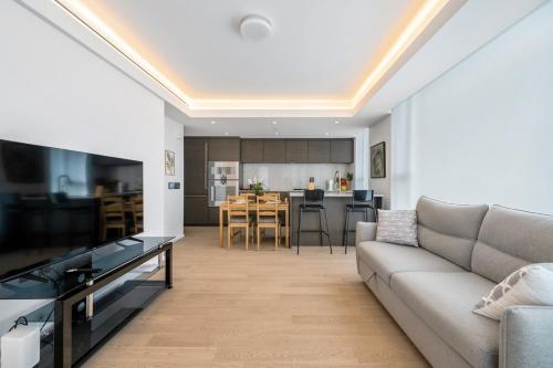 a living room with a couch and a kitchen at Urban Retreat 2BR Condo with Stunning City View in Vancouver