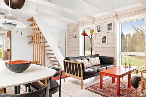 a living room with a couch and a table at SKA601-Roeke-Roeke-Algustorp-4198 in Röke