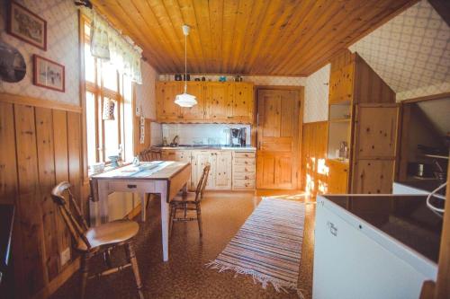 a kitchen with wooden cabinets and a table and chairs at JON707-Burseryd-Moerkebo-2 in Burseryd