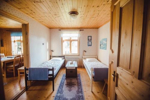 a room with two beds and a table in it at JON707-Burseryd-Moerkebo-2 in Burseryd