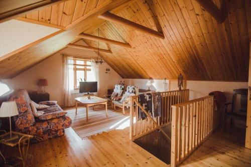a large living room with wooden ceilings and a wooden staircase at JON707-Burseryd-Moerkebo-2 in Burseryd