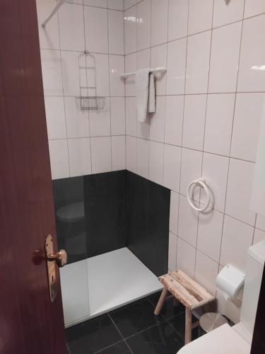 a bathroom with a shower with a bench in it at Porto 1 Bedroom Beach Apartment in Matosinhos