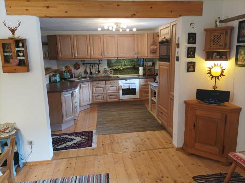 a kitchen with wooden cabinets and a stove top oven at Ferienwohnungen Dopplerhof in Piding