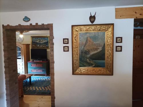 a framed painting on a wall in a living room at Ferienwohnungen Dopplerhof in Piding
