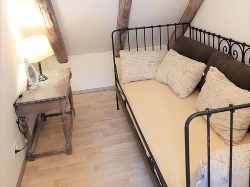 a bedroom with a bed and a table with a phone at Dat Mullworp Huus in Hagermarsch