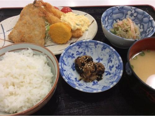 a table with plates of food and bowls of rice at Hotel Tetora Hachinohe - Vacation STAY 12756v in Hitoichi