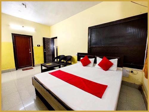 a bedroom with a large bed with red pillows at Hotel Moon Suncity Near Sea Beach 200m And Jagannath Temple in Puri