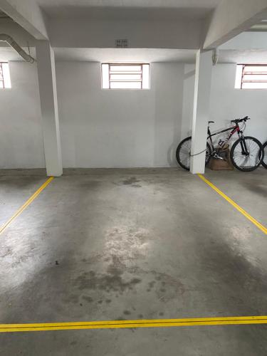 a garage with two bikes parked in it at Fique a 2min da Igreja Canela in Canela
