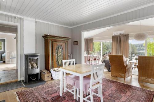 a dining room with a table and a living room at OGO368-Boxholm-Tingkullanaes-6 in Blåvik