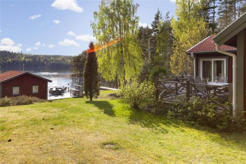 a house with a view of a lake and a dock at OGO368-Boxholm-Tingkullanaes-6 in Blåvik