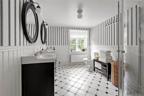 a white bathroom with a sink and a mirror at HAL484-Unnaryd-Yas-108 in Realsbo