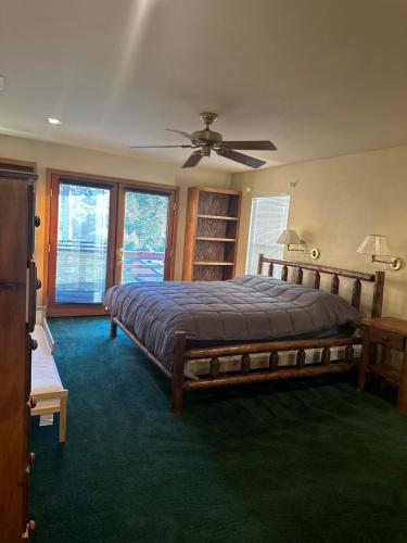 a bedroom with a large bed and a ceiling fan at Charming Pine Mountain Home with Family Space in Frazier Park