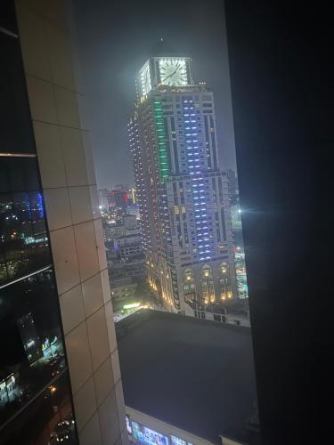 a view of a city at night from a skyscraper at PHANTOM ,Buisness Master Suite Private Toilet , Horizon,AJMAN in Ajman 