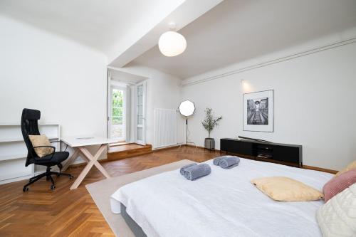 a white bedroom with a bed and a desk at Luxury Villa style, best view, terrace, BBQ, 2BR, 2-bath in Tallinn