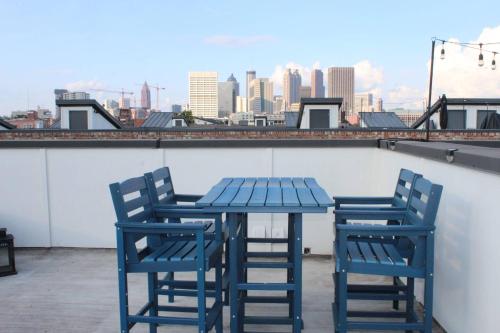 two blue chairs and a table on a roof at Spectacular Vista in Atlanta