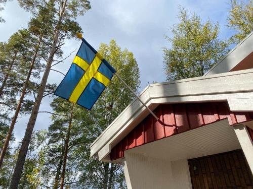 a flag flying on top of a house at GAV757-Norrala-Kungsgardssjoearna-287 in Norrala